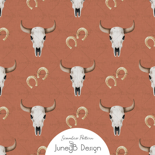 Western longhorn skull and horseshoe seamless pattern with blush florals on rust background digital fabric design.
