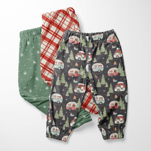 Set of kids’ Christmas camper pajama pants with holiday RV, plaid, and snowflake prints.